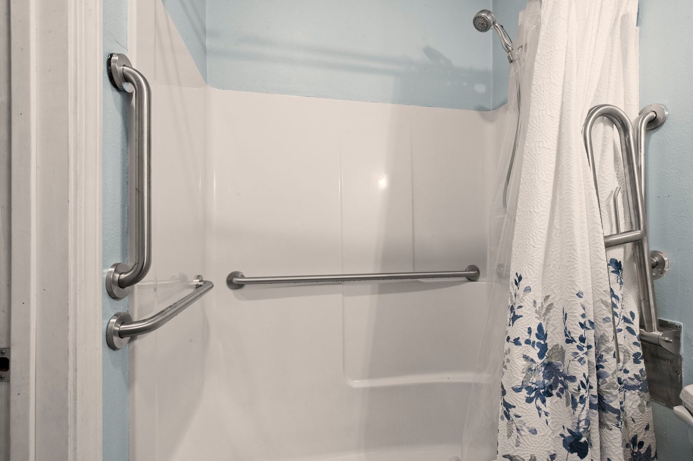 Accessible walk-in shower with safety grab bars