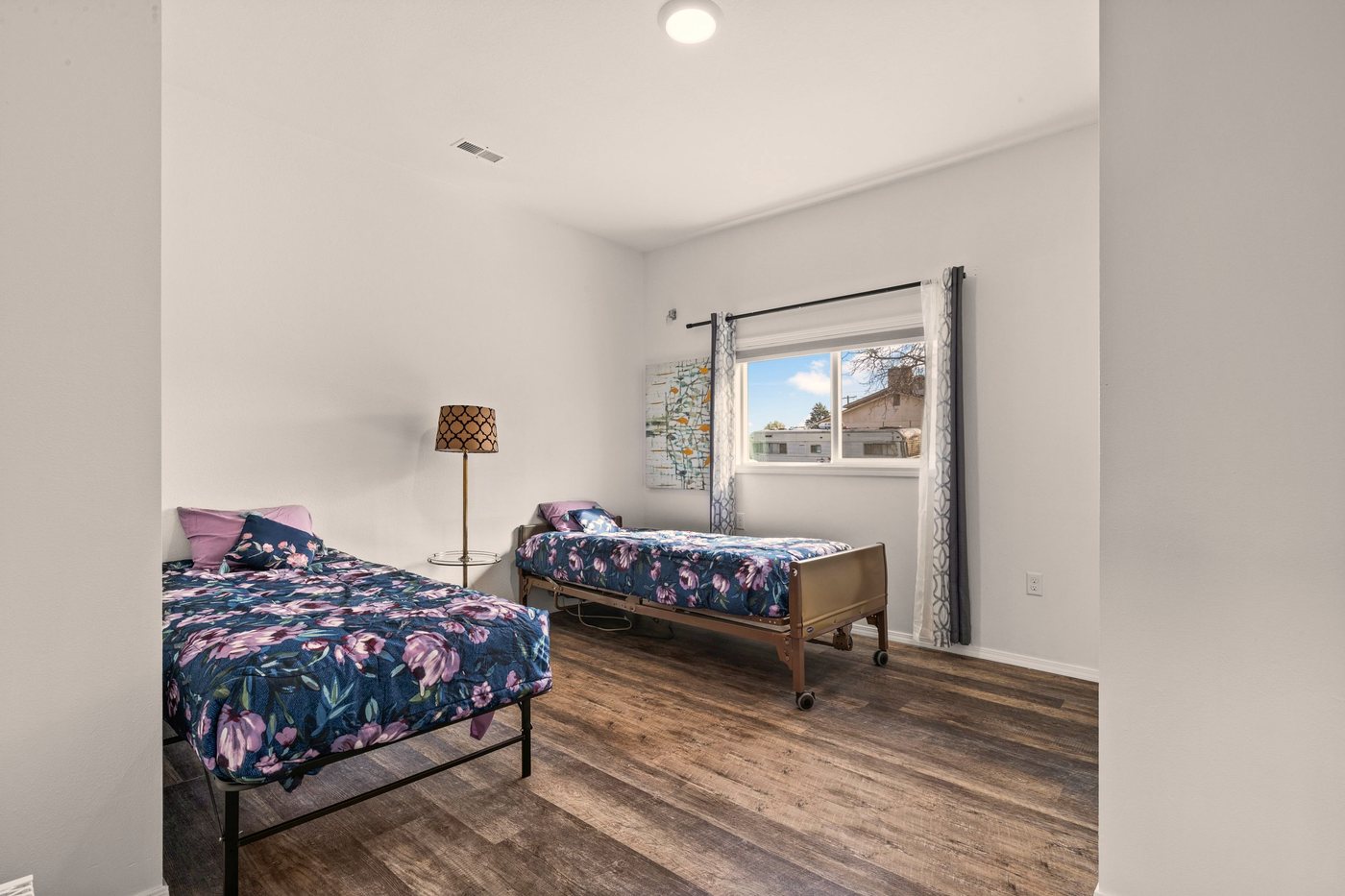 A bright shared bedroom with comfortable beds
